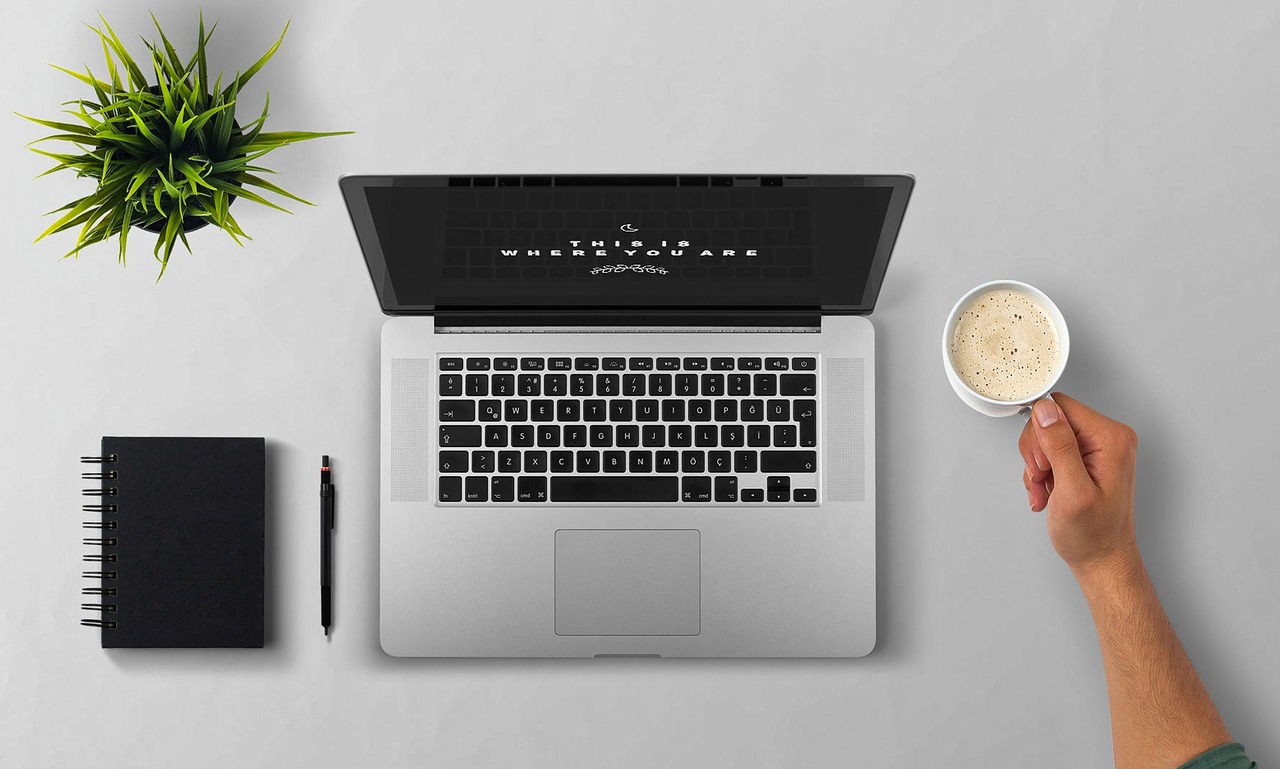 Laptop, coffee, arm — Blu-ray's The Next DVD in Technology