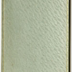 A closed, textured book with a light green cover and gold lining