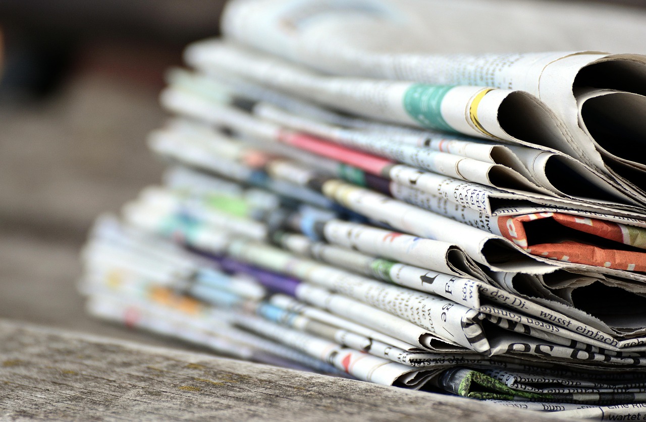 Newspapers, pile of newspapers, press — What Are The Advantages Of Selling Online?